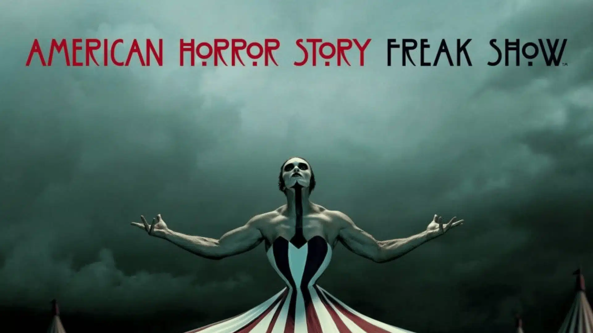 American Horror Story Freak Show poster showing performer with arms outstretched beneath stormy sky and circus tent base, title