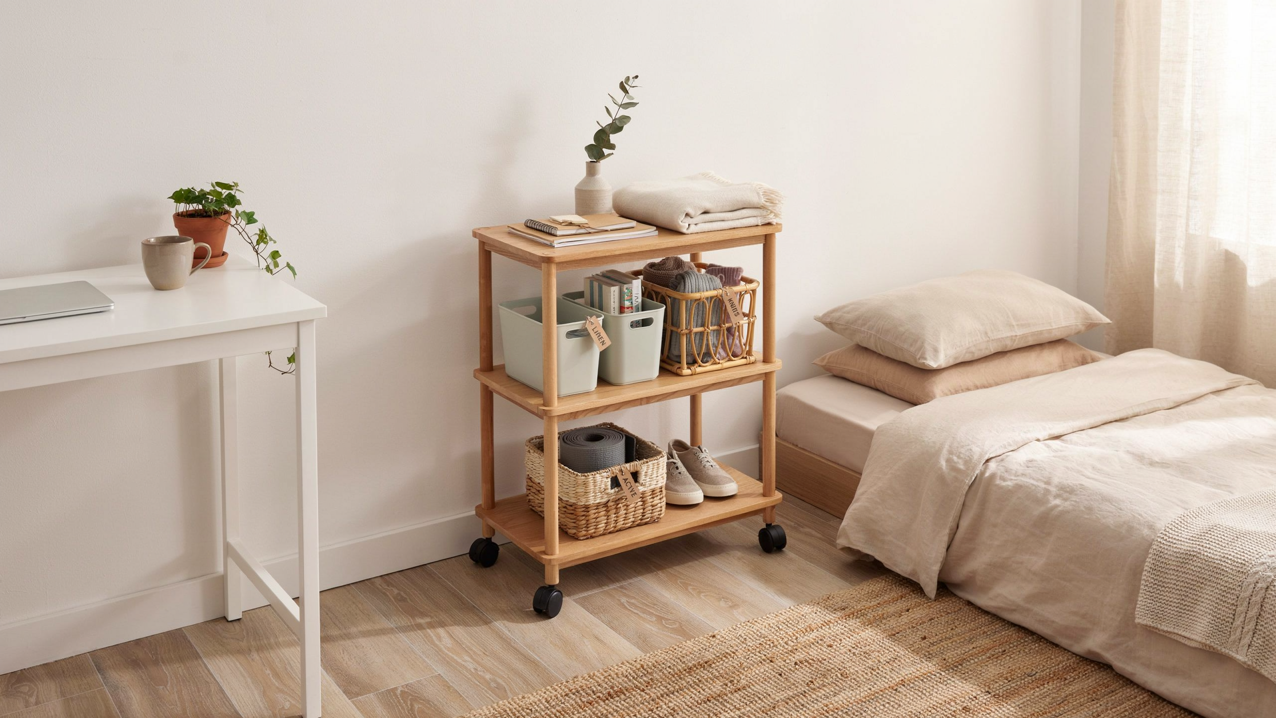 Tidy bedroom showing rolling cart with organized bins, easily movable, minimalistic, soft natural lighting, realistic room scene.