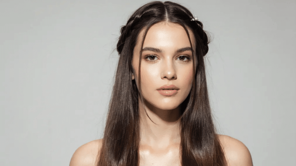Half-up twist with smooth straight lengths, soft Y2K glam hairstyle with polished early 2000s clean look
