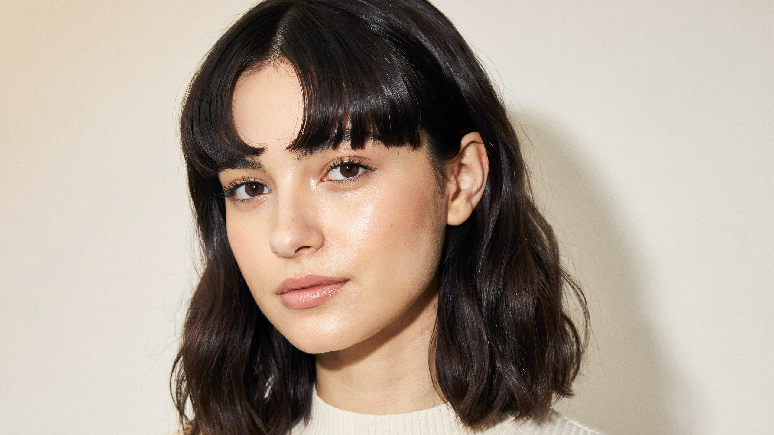 Bow fringe styled with a round brush into a rounded upward curve for a retro voluminous look