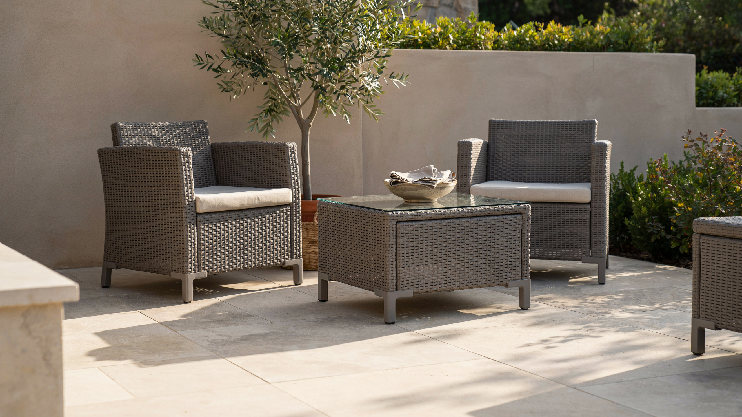 Resin wicker patio furniture realistically arranged.