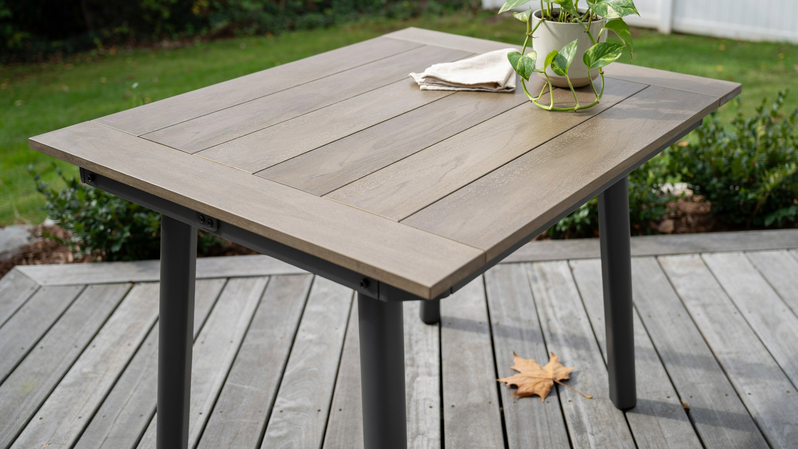 Composite patio table on a deck.