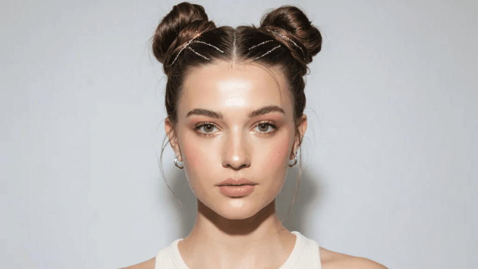 High space buns with glitter strands woven through, bold Y2K party hairstyle with playful early 2000s energy look