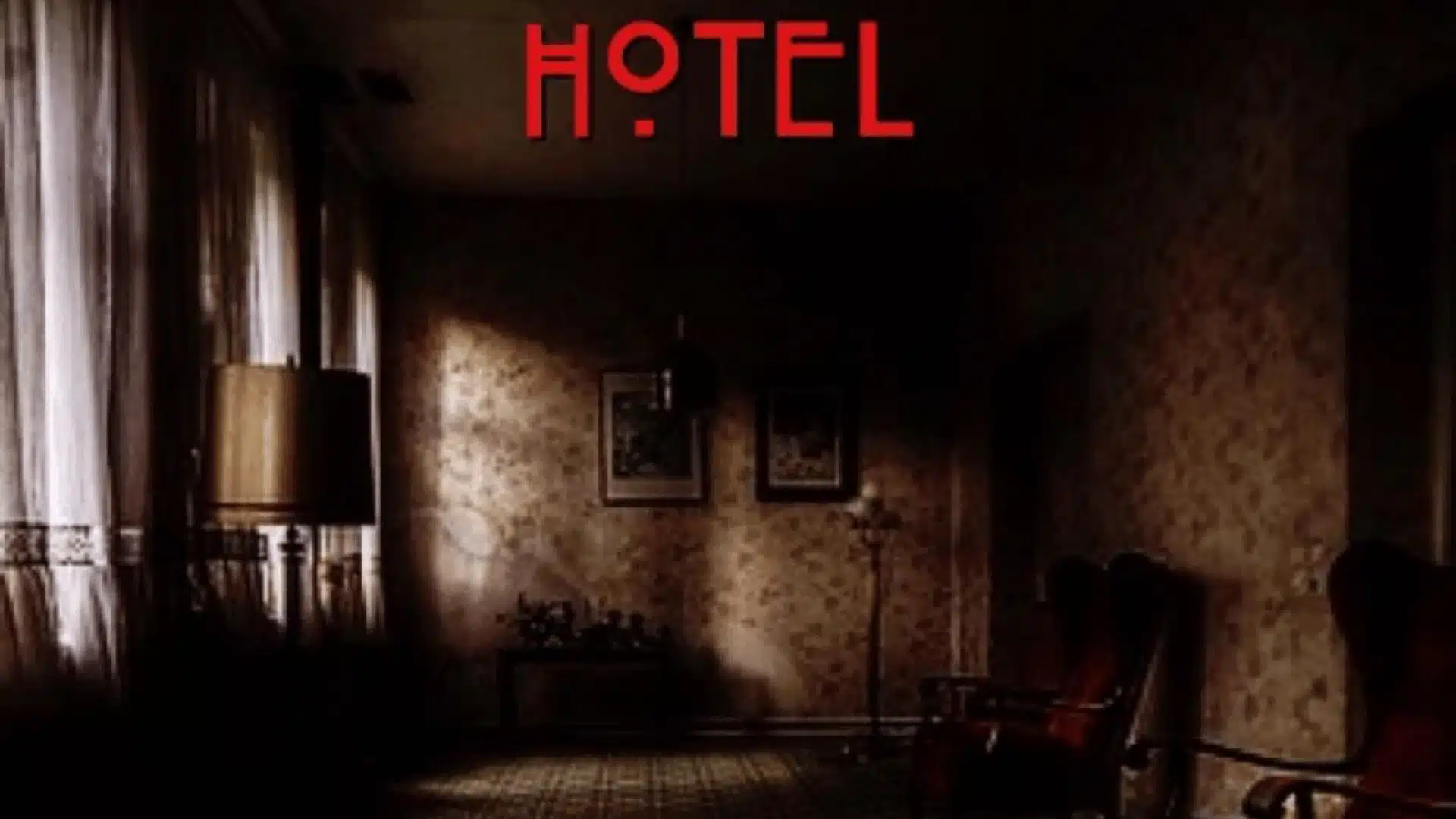 American Horror Story Hotel poster showing dim vintage hotel room corridor with patterned rug, red chairs, and title text.