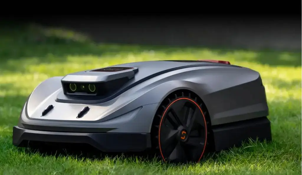 Robotic lawn mower with sleek design on green grass under natural daylight