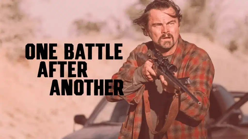 Man in a plaid shirt holding a rifle in a desert setting with the text "One Battle After Another" overlaid on the left.