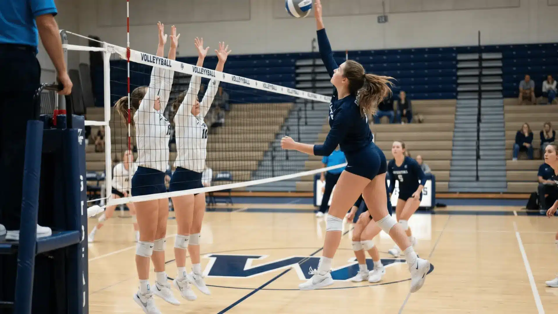 Opposite hitter attacking a volleyball from the right side of the net