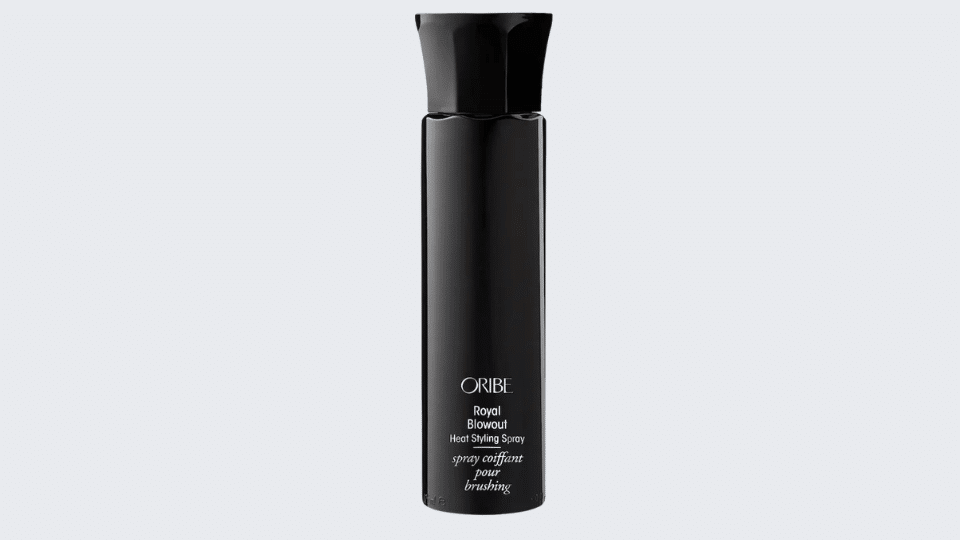 Oribe Royal Blowout heat styling spray bottle on plain background