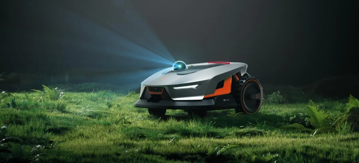 Autonomous robotic lawn mower on grassy terrain with laser projector and sleek design in low light
