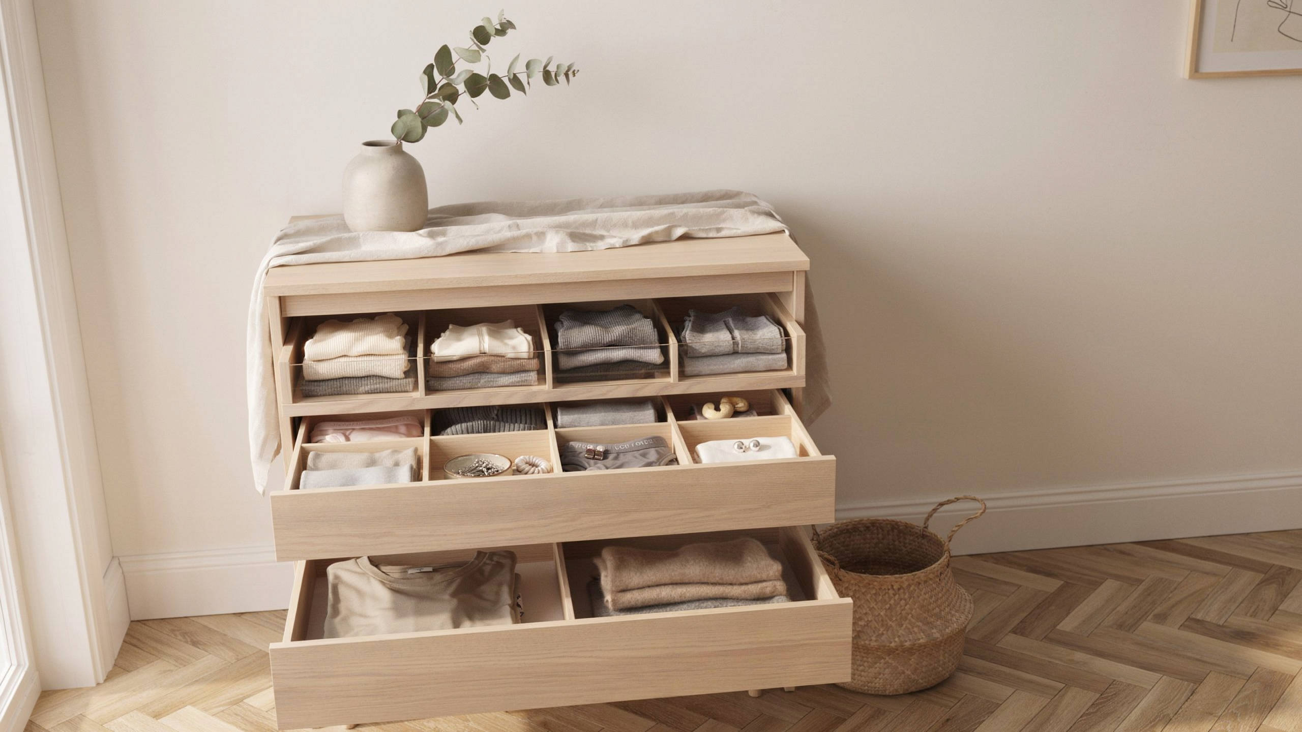 Open dresser drawers showing dividers separating clothes and small items, minimalistic, clean organization.