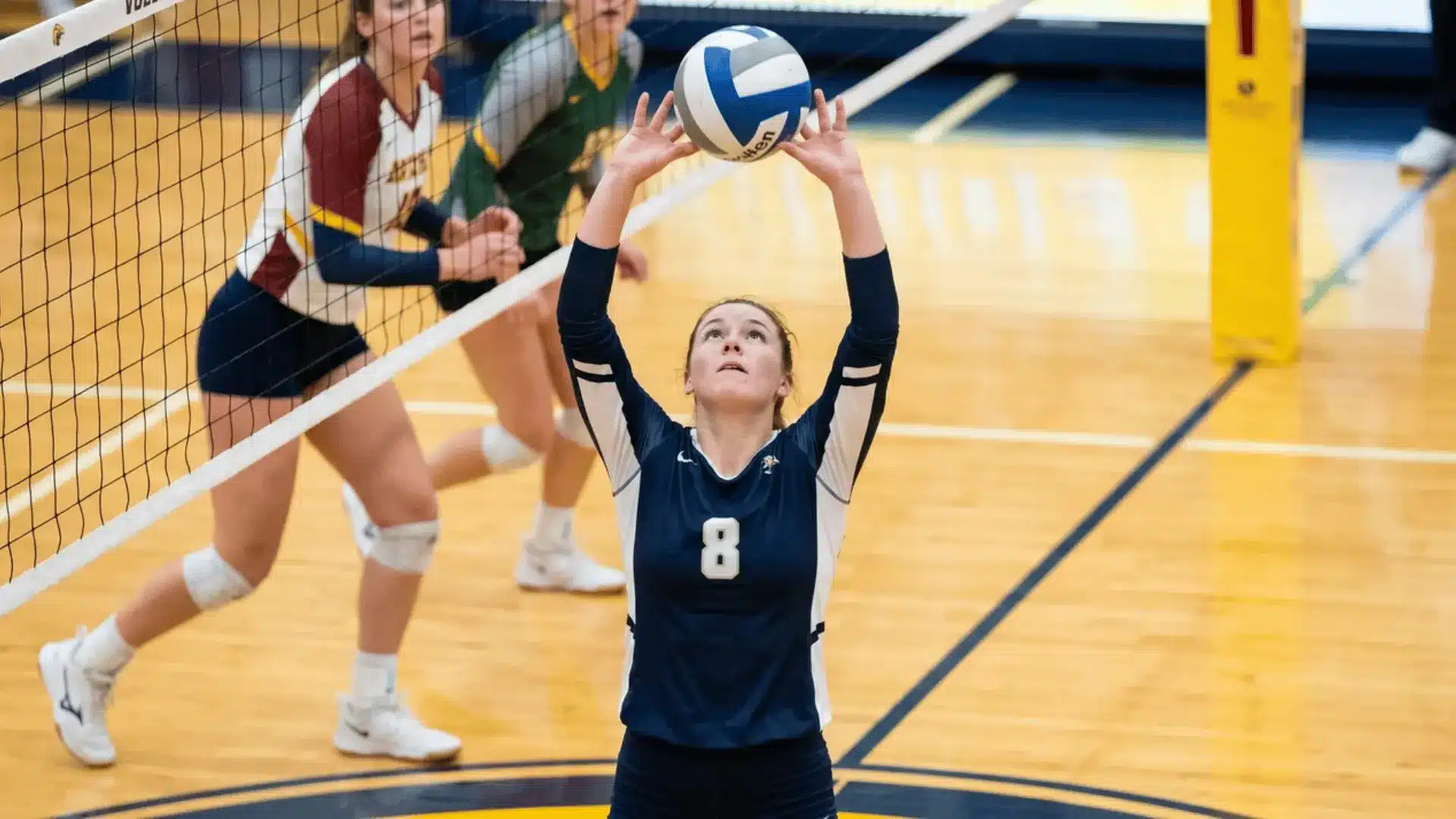 Volleyball setter making an overhead set near the net during a rally