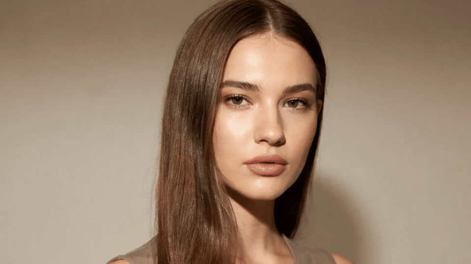 Side part sleek straight hair with glossy finish, classic Y2K soft glam hairstyle with smooth polished look