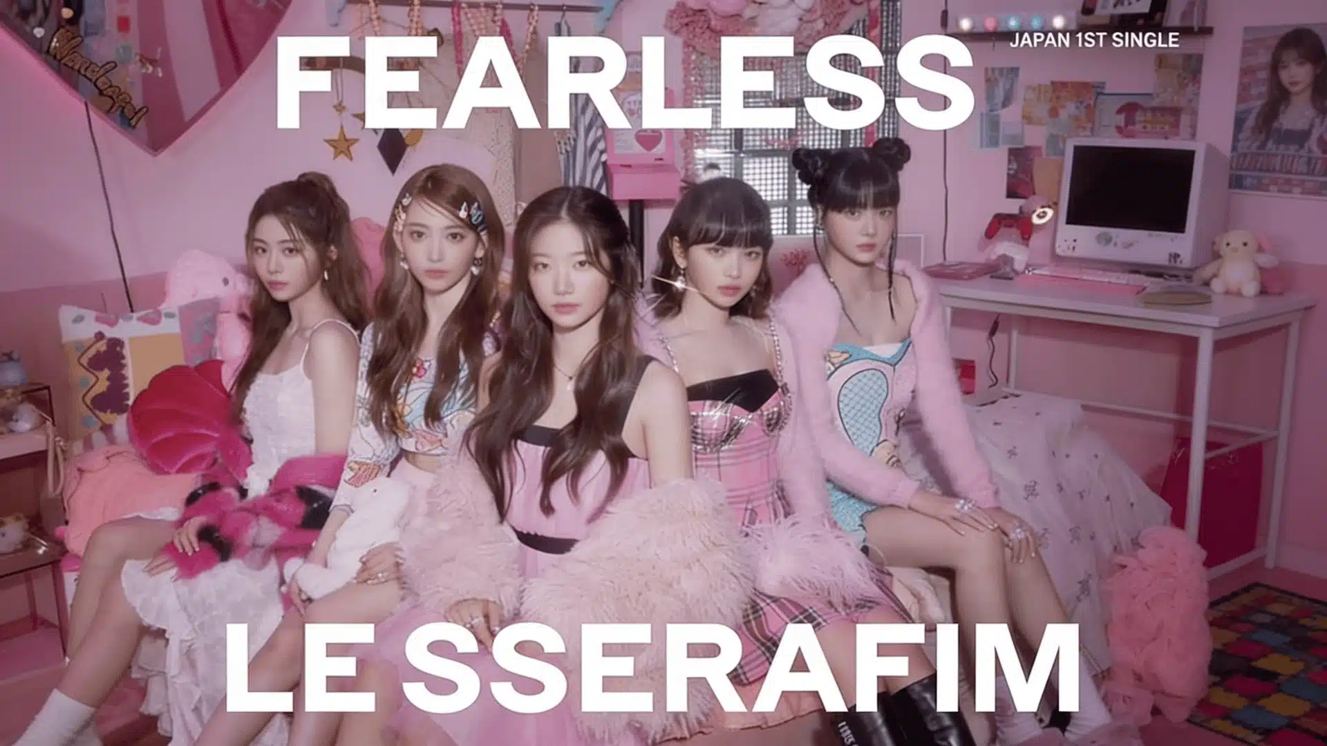Five-member K-pop girl group seated in a pink-themed bedroom-style set with nostalgic decor, posing for a concept shoot with “FEARLESS” text above.