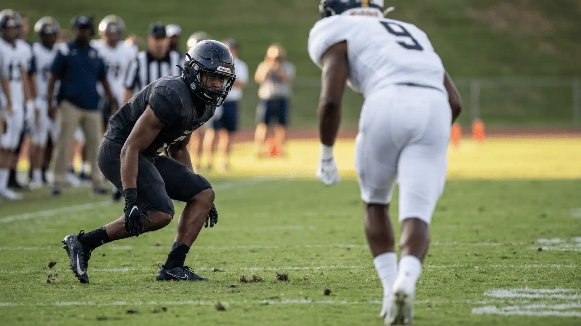 Defensive back anticipating a pass, demonstrating strategic importance of PBUs