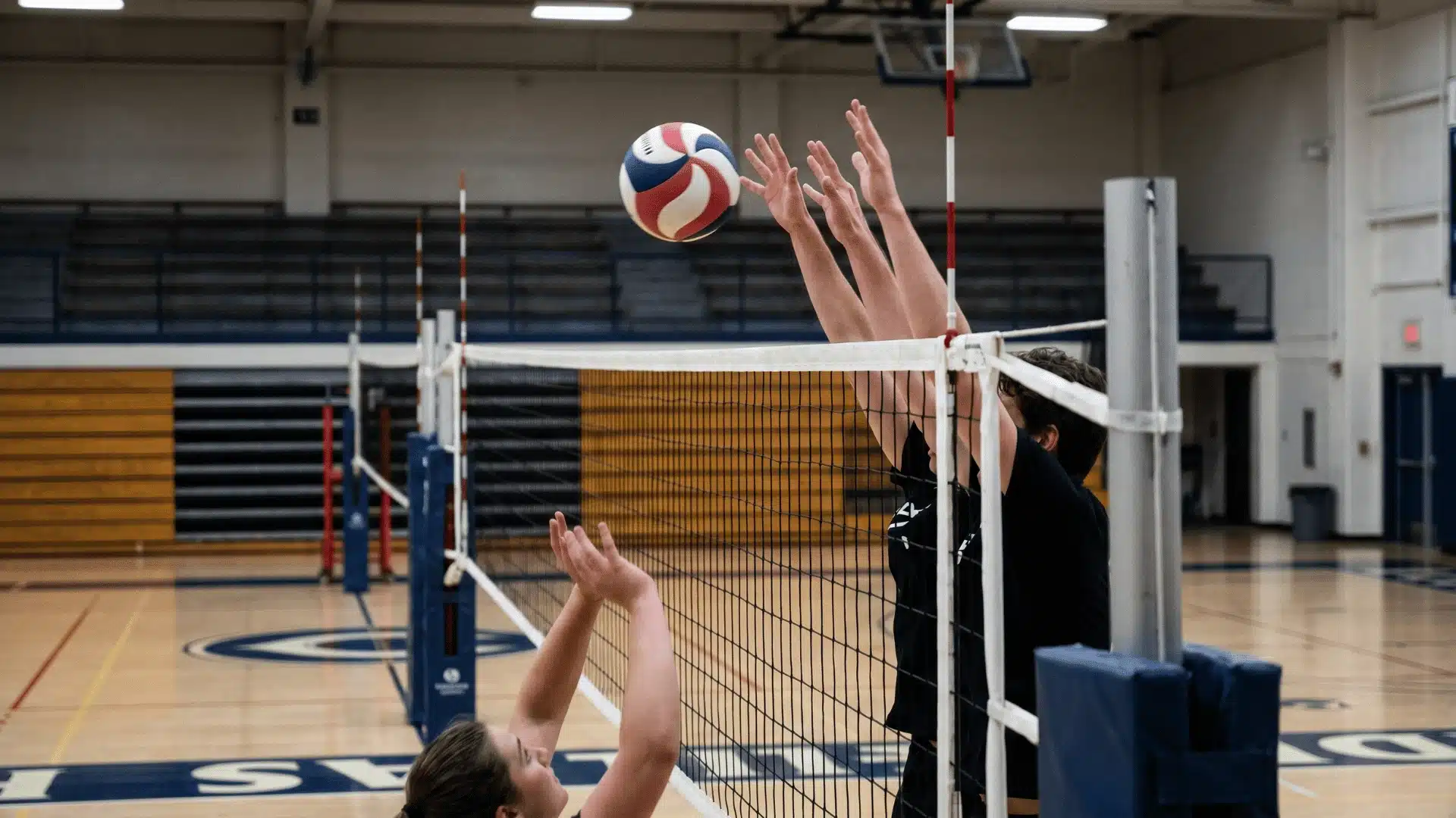 Volleyball team running a structured attack after a clean pass during serve receive.