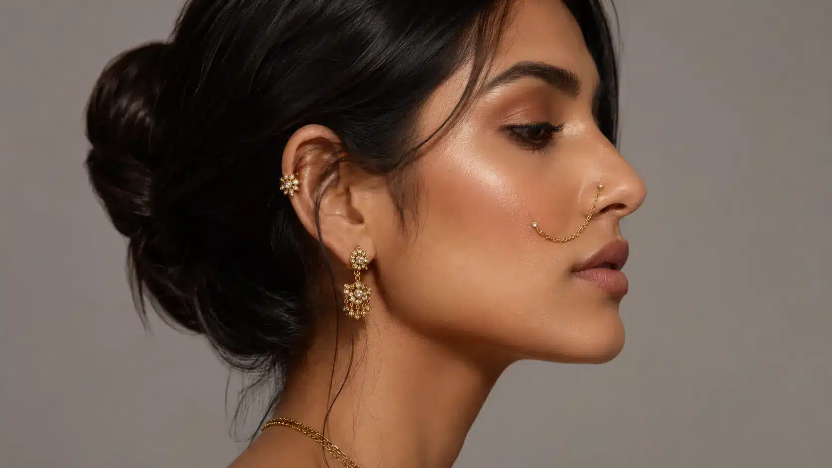 Woman wearing paired nostril piercings connected by a chain