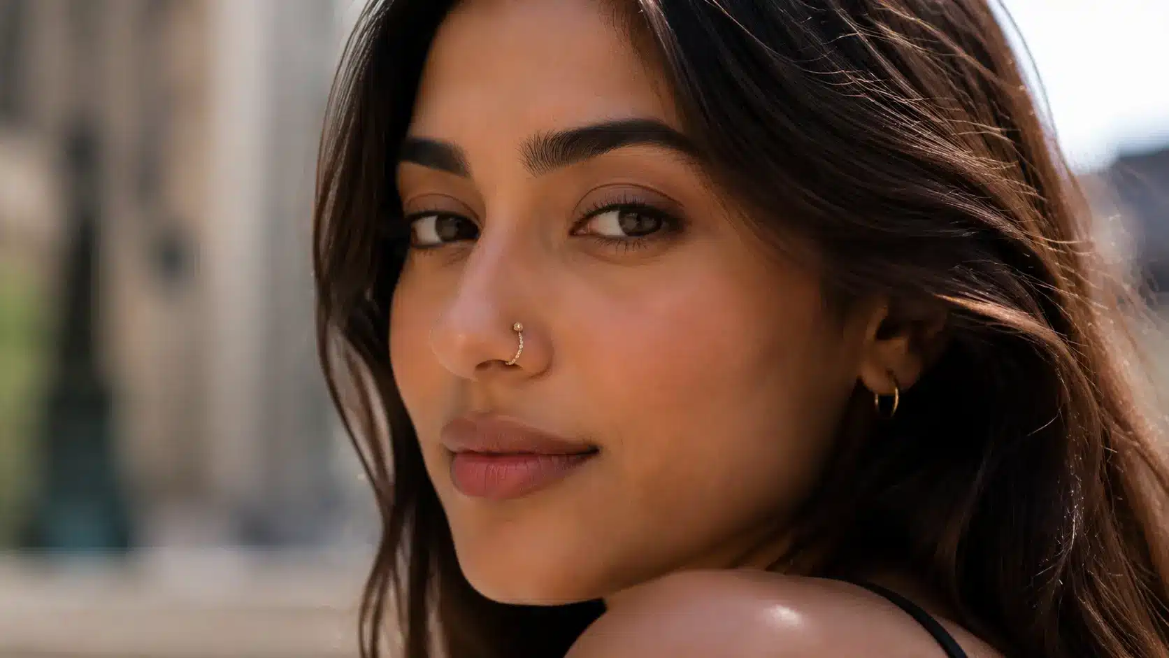 Woman with double nostril piercings and layered nose jewelry