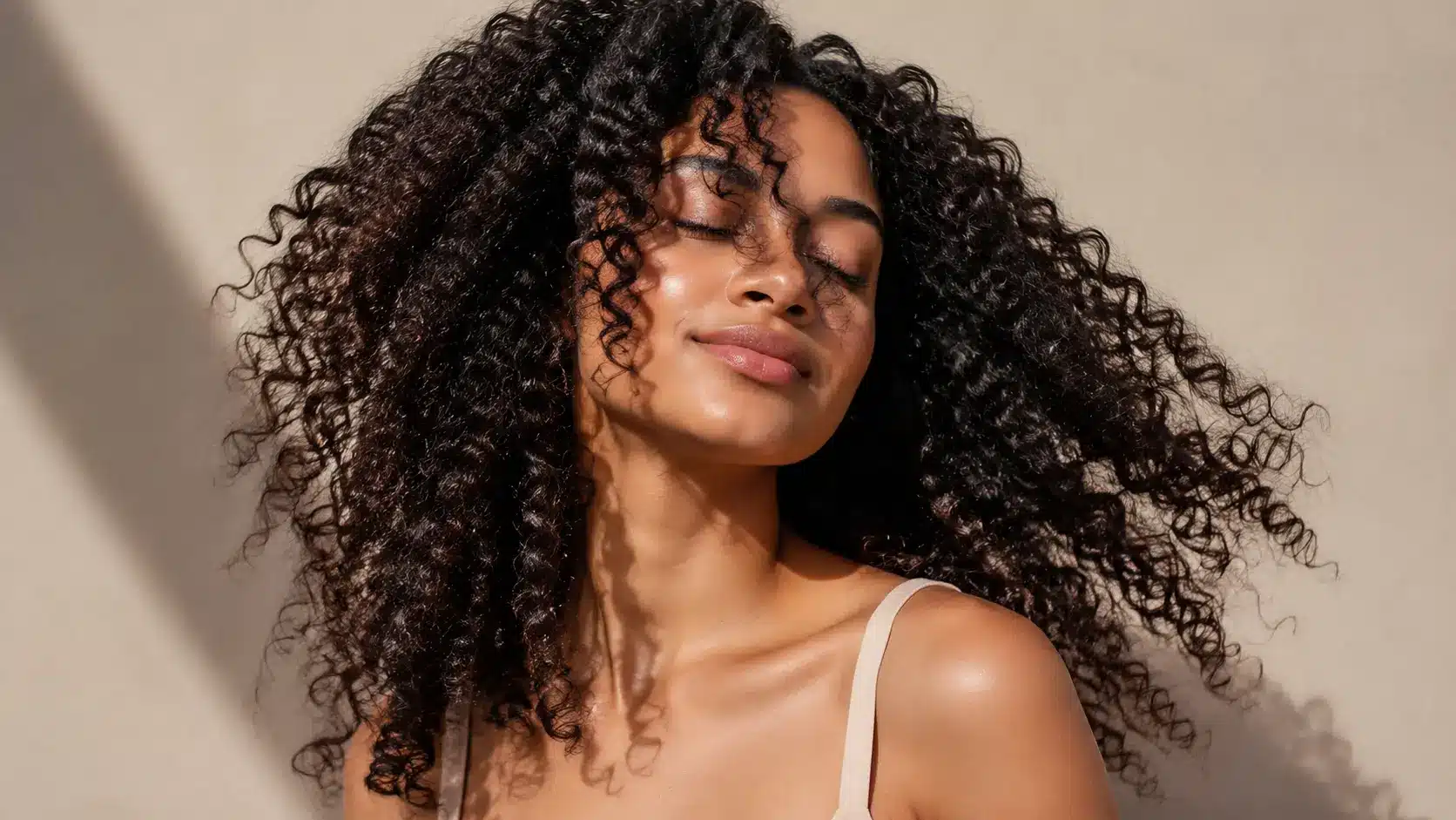 Woman with healthy, defined curly hair and natural volume