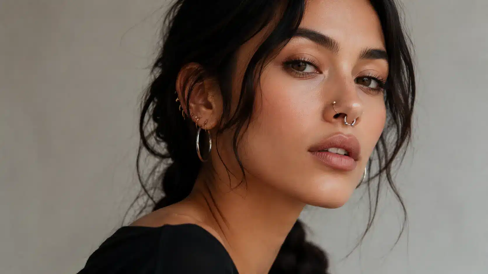 Woman with mixed gold and silver facial piercings