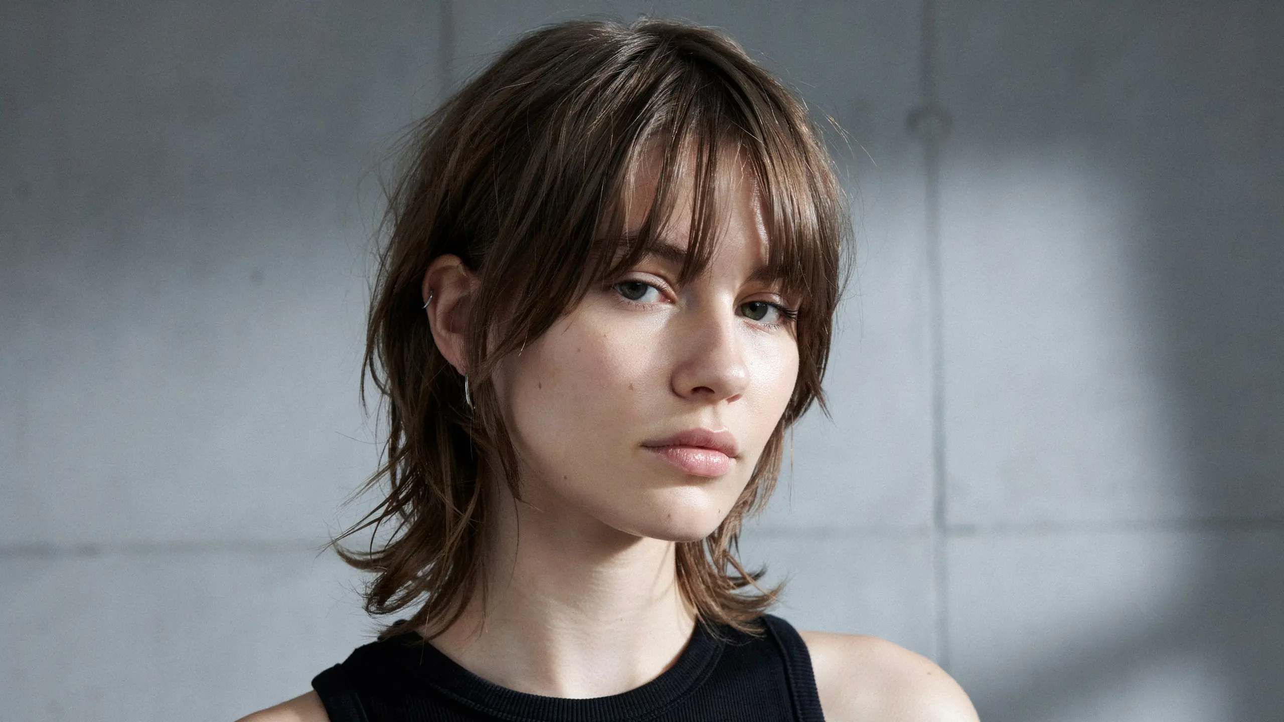 Asymmetrical fringe with uneven bangs creating a modern edgy hairstyle