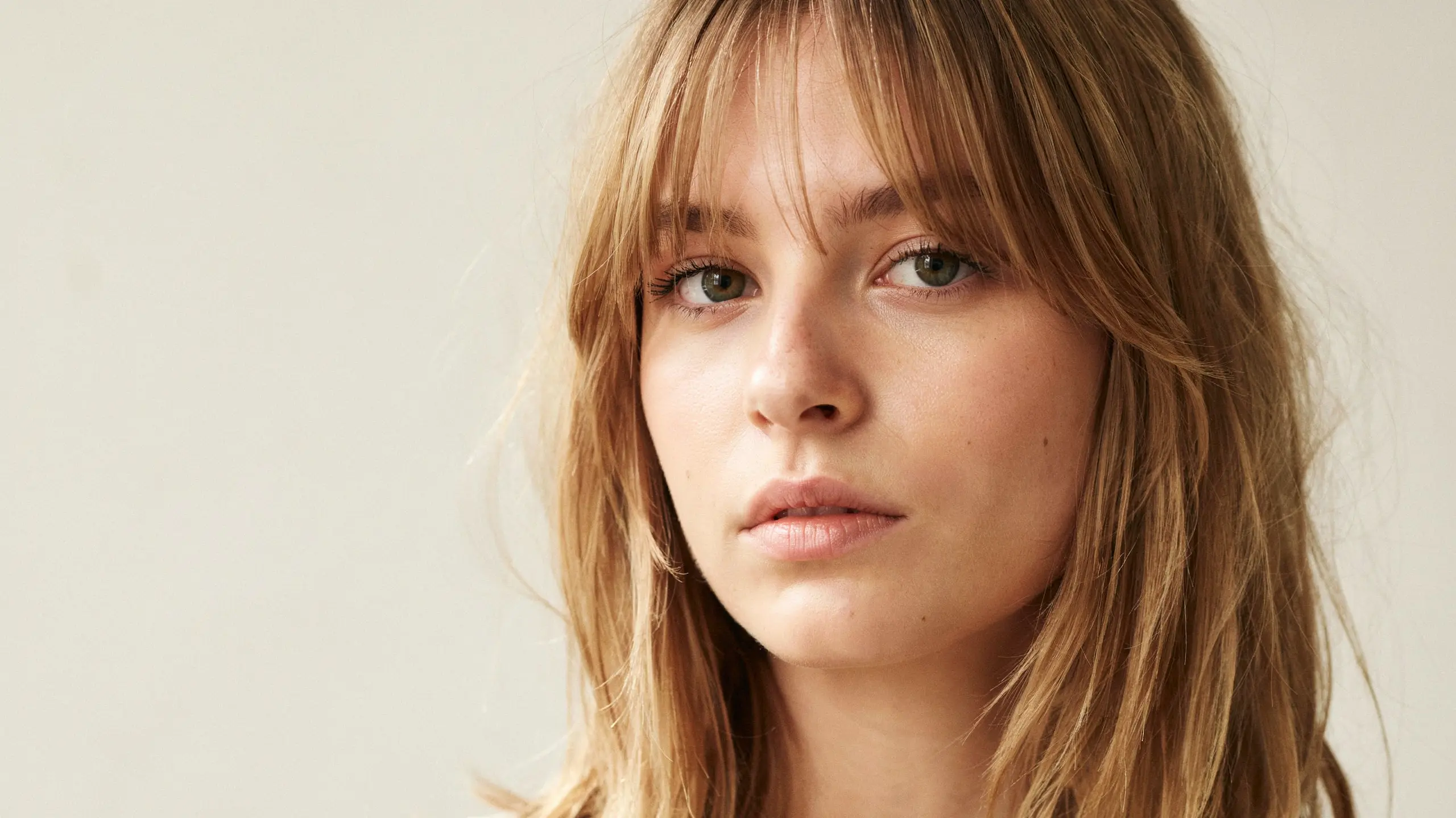 Birkin bangs hairstyle with soft full fringe and straight hair for a classic chic appearance