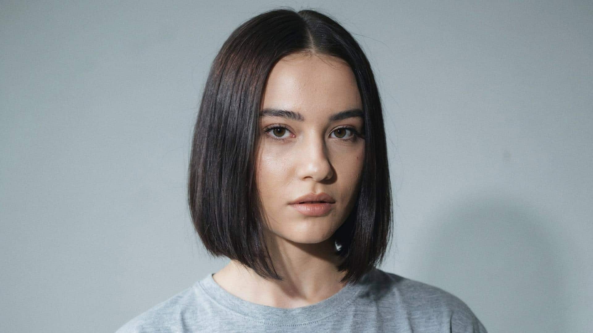Sleek blunt bob with a center part and straight, glossy ends.