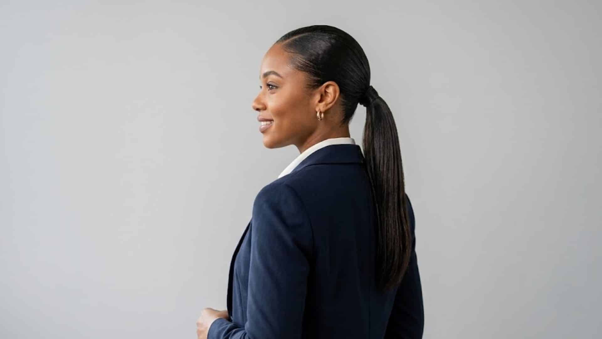 Woman in a blazer wearing a classic slicked-back low ponytail