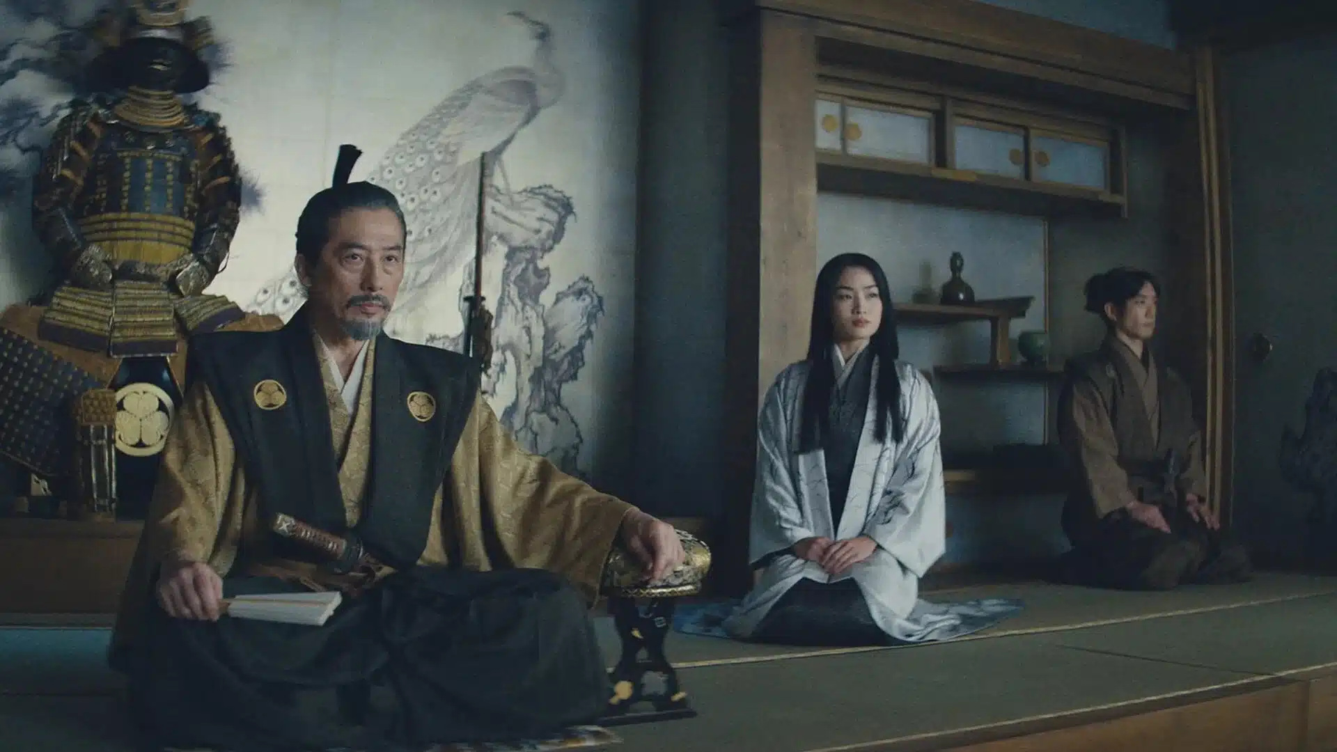 Dramatic Shōgun moment showing a samurai ruler with companions inside a dimly lit Japanese residence