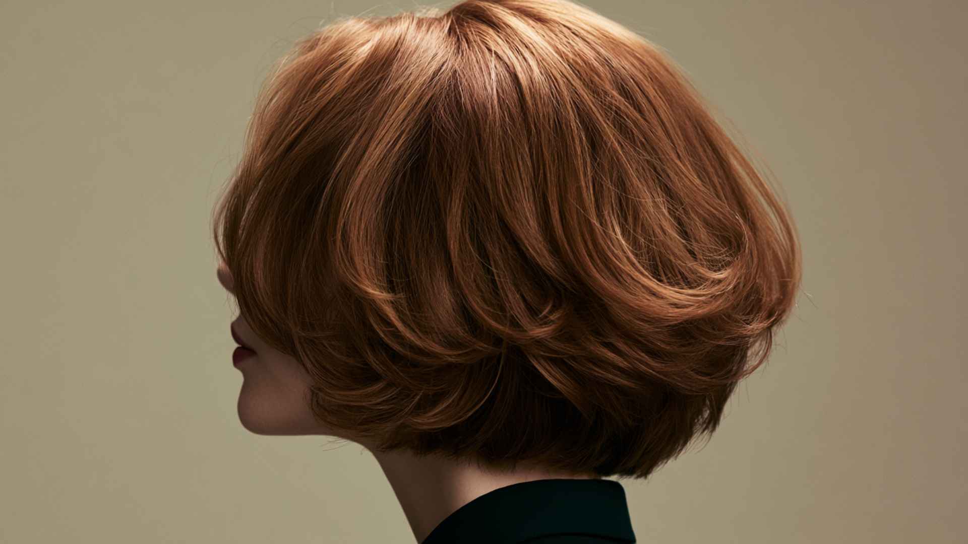 Woman with an ear-grazing layered bob featuring textured layers and soft facial volume.