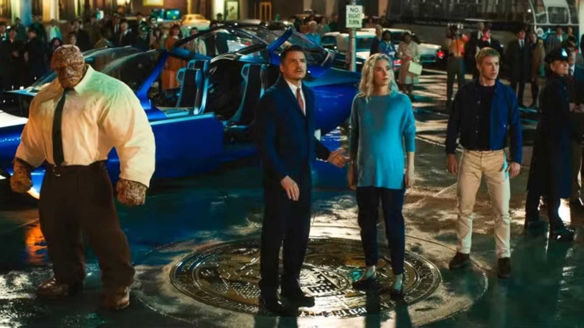 Fantastic Four stands together on a rain-soaked city street as crowds gather around during a tense moment.