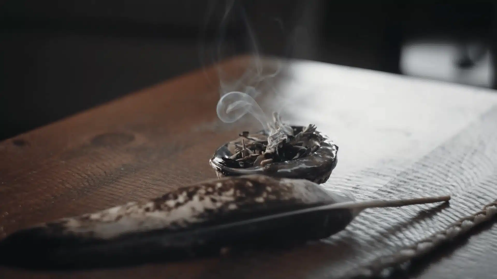 Sage bundle resting in a fire-safe bowl after completing a cleansing ritual