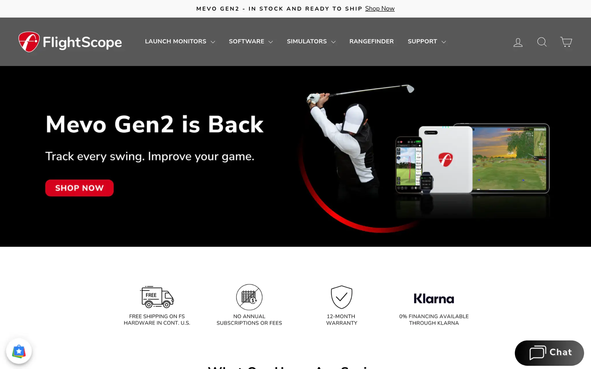 Golfer swinging club next to electronic devices displaying golf simulation software in a dark background