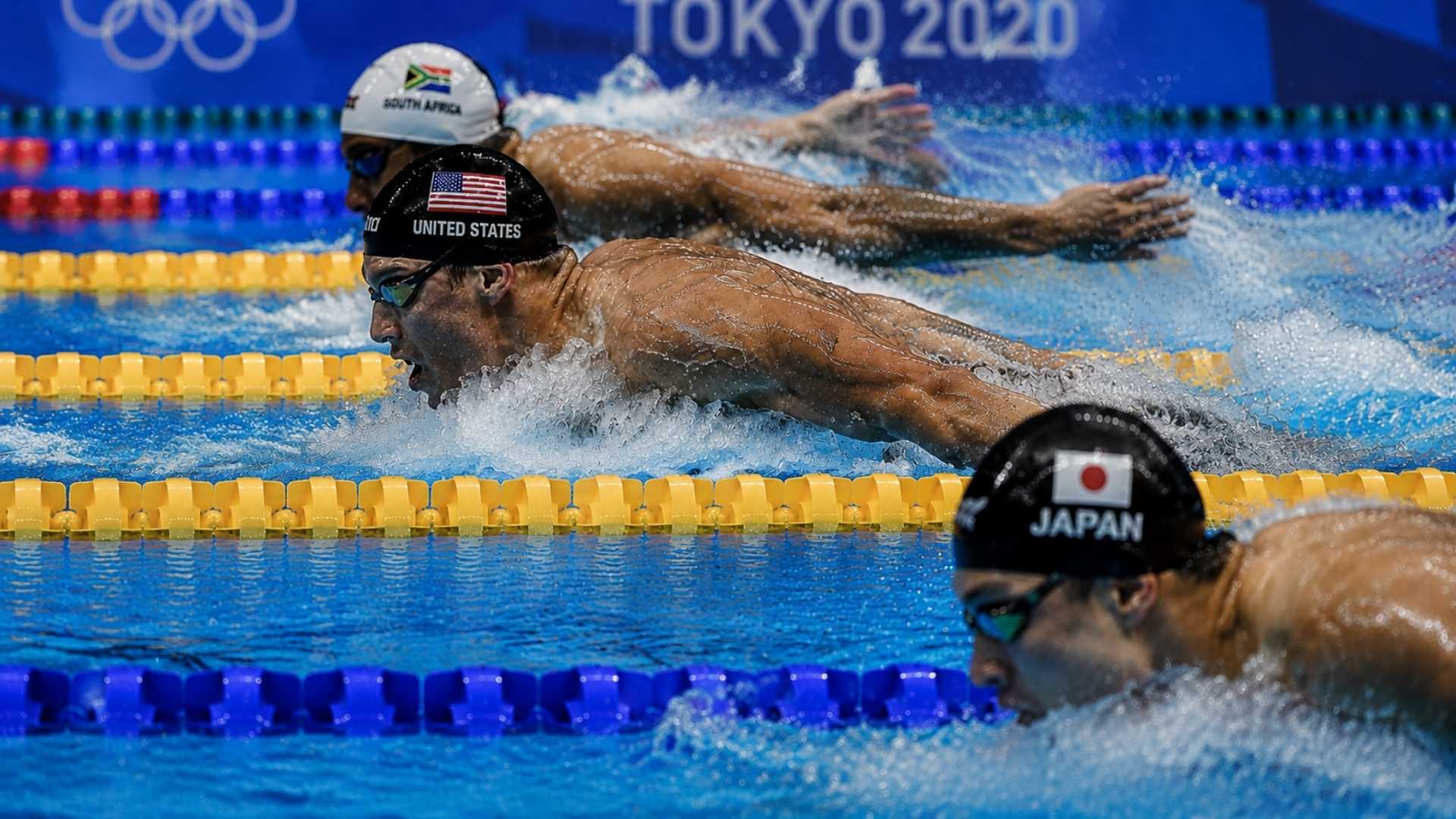 Swimming race with USA, Japan and South Africa swimmers in Olympic pool lanes, intense finish