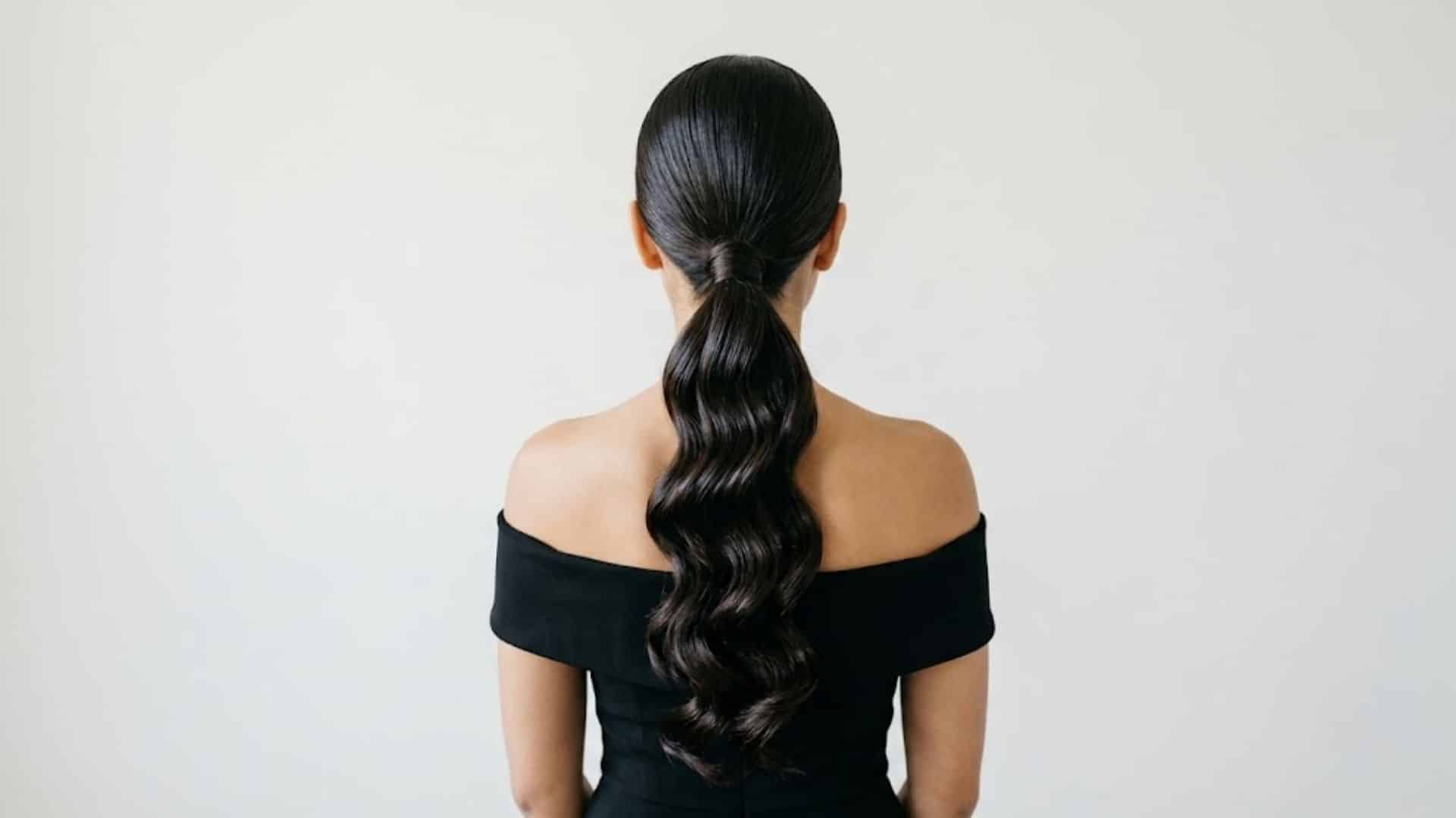 Sleek ponytail styled with glamorous Hollywood waves