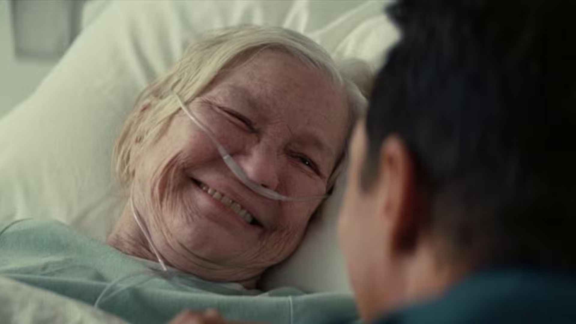 Elderly Murph smiles at Cooper during their emotional reunion in the hospital near the end of Interstellar.