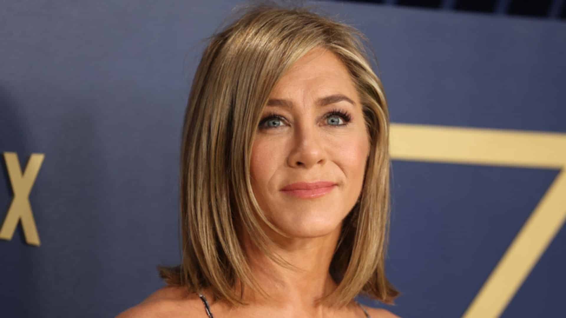 Jennifer Aniston with a soft layered bob, side-parted blonde hair