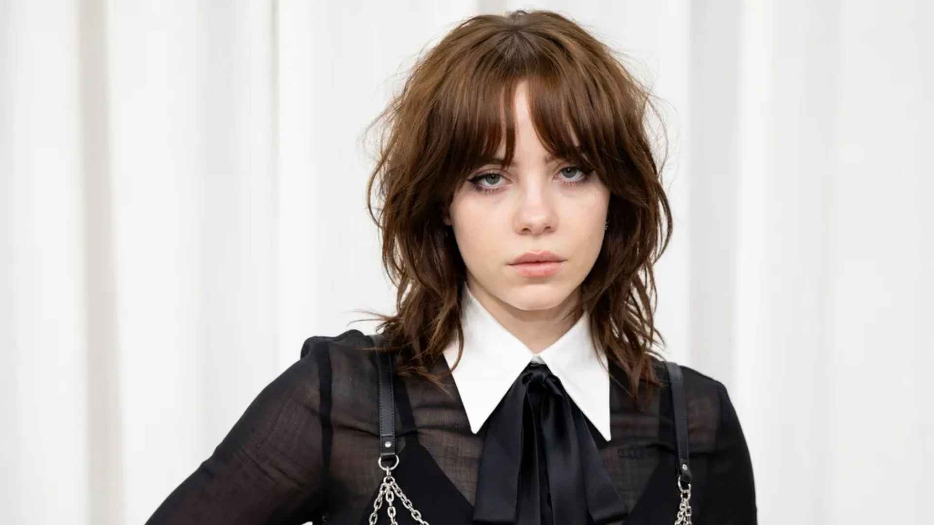 Woman with a wolf cut layered bob featuring choppy layers, fringe, and crown volume.
