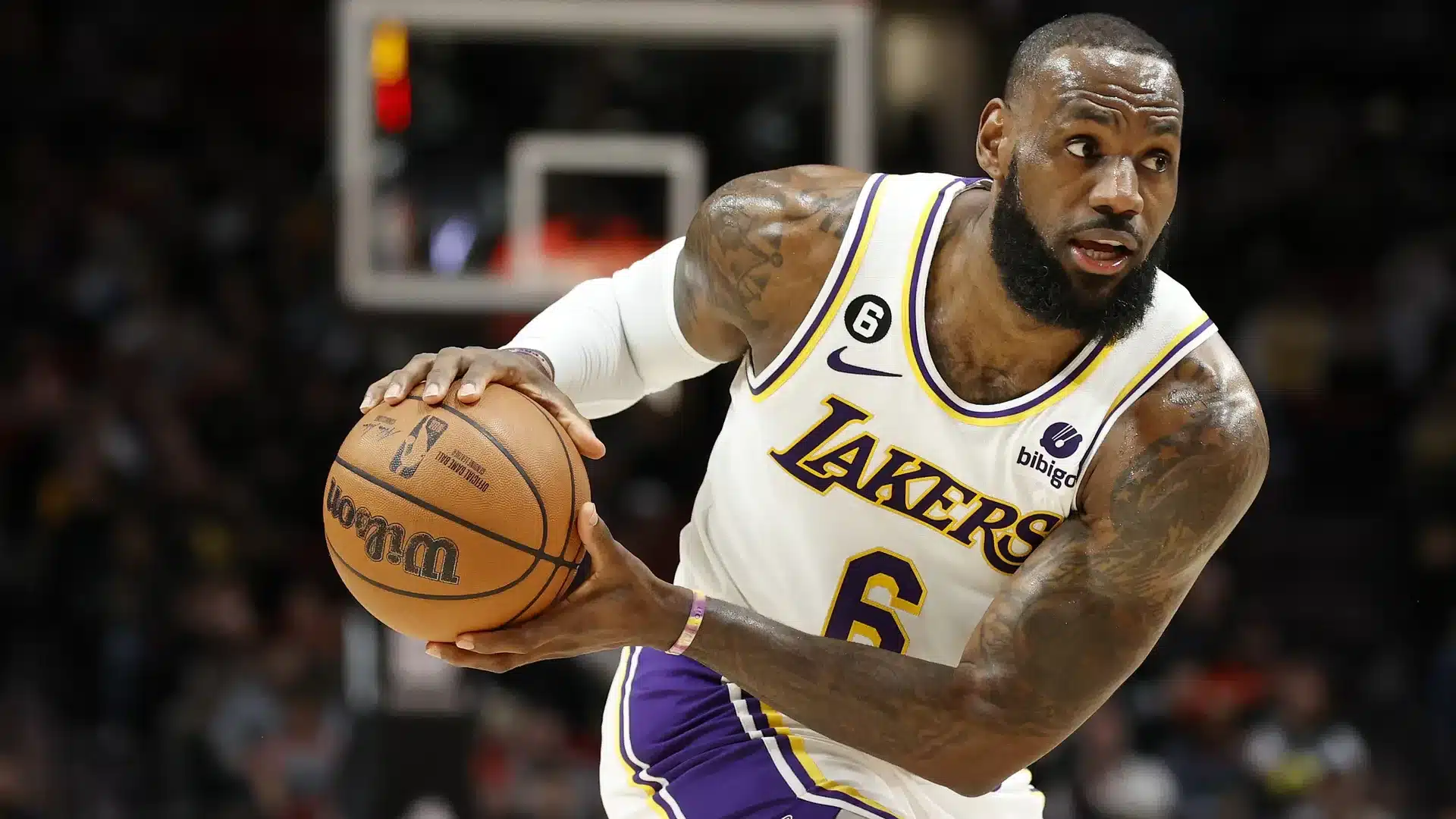 LeBron James dribbling the basketball during a Lakers game, showcasing his iconic NBA career and leadership.