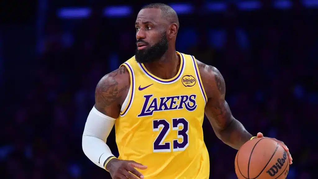 LeBron James wearing a Lakers jersey dribbles a basketball during an NBA game