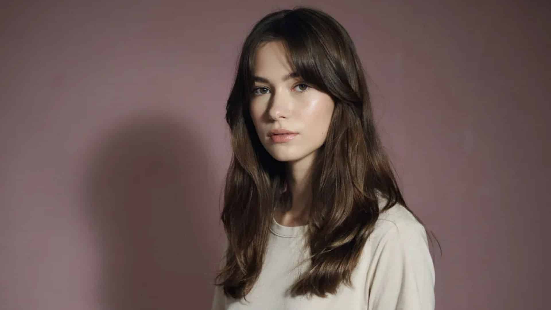 Long wolf cut with wispy bangs and shaggy, feathered layers.