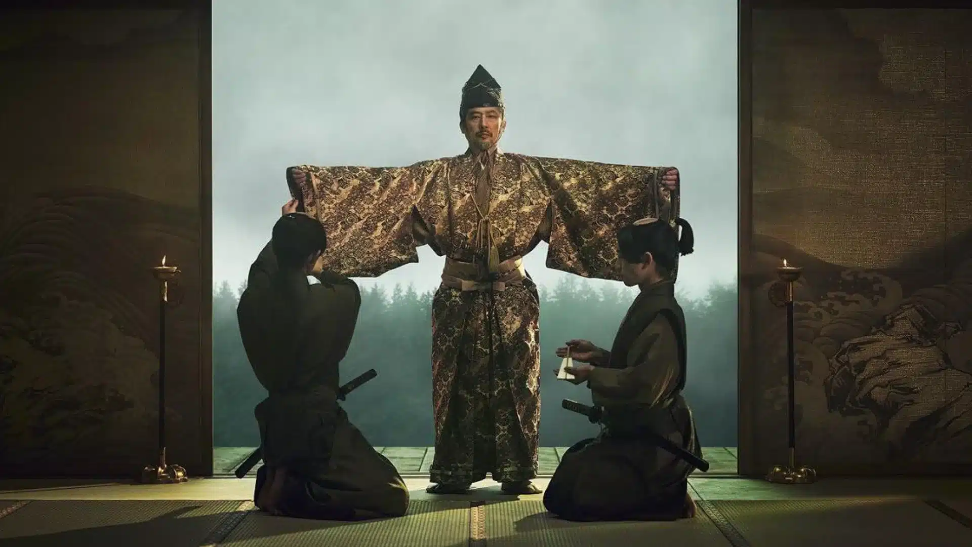 Lord Toranaga stands in ceremonial robes with outstretched sleeves as attendants assist him inside a traditional Japanese hall