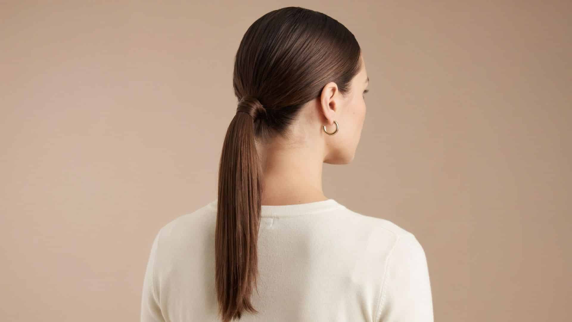 Back view of a low slick ponytail with a wrapped hair tie