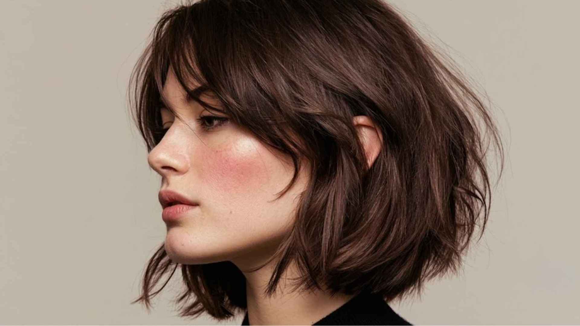 Woman with a razor-cut layered bob featuring wispy ends and soft airy layers.
