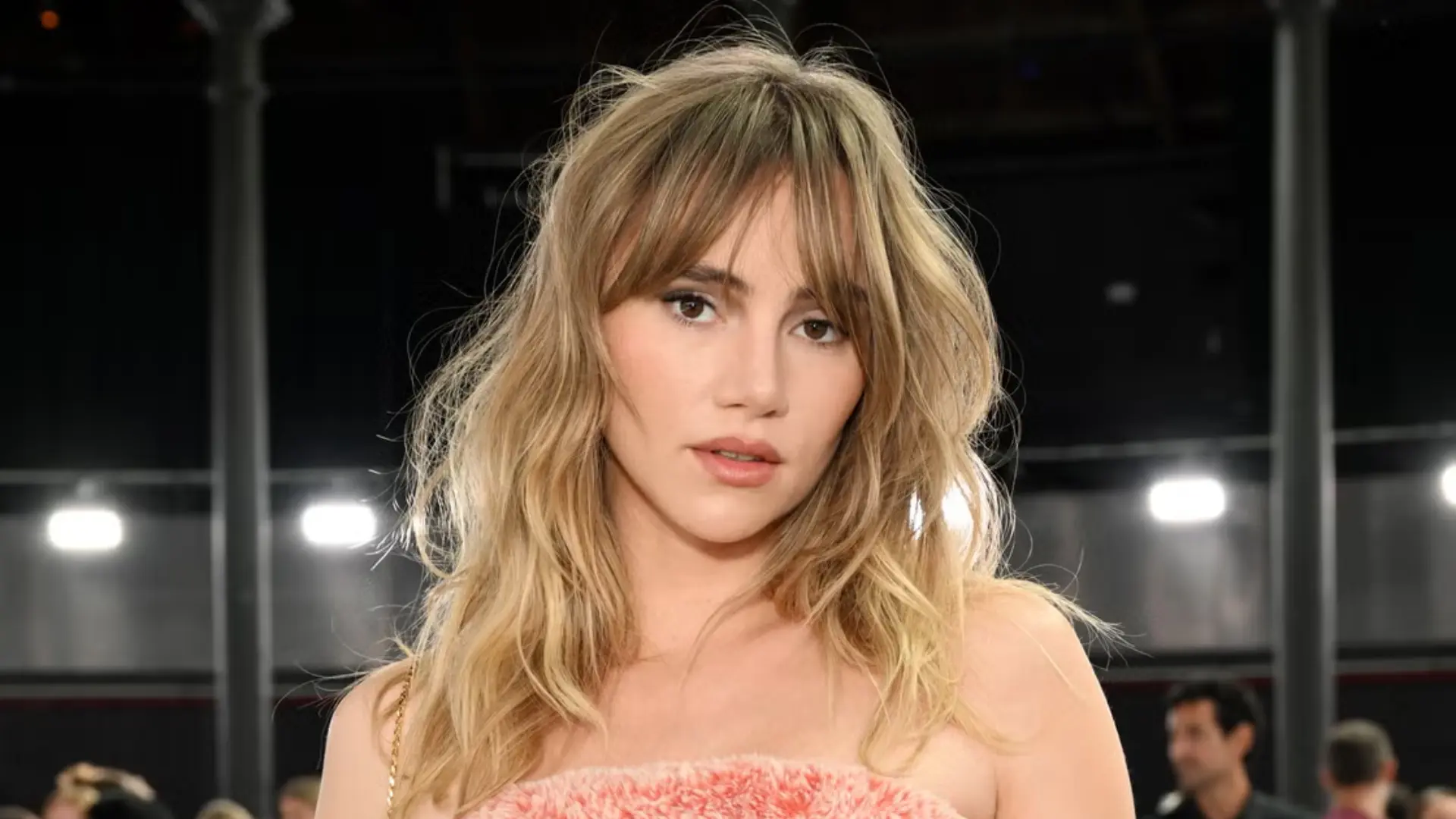 Shaggy bangs with choppy layers and messy waves creating an effortless hairstyle