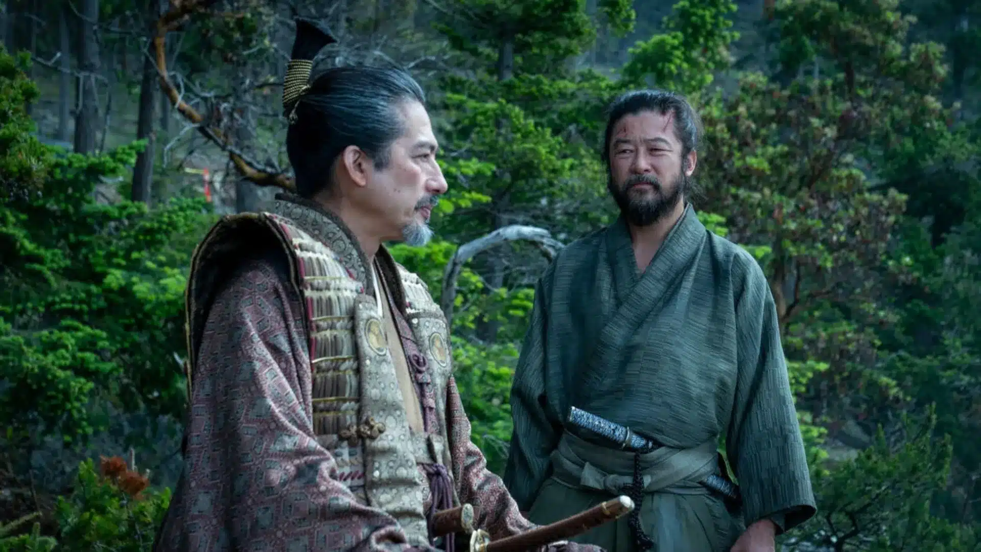Shōgun scene showing two Japanese warriors in traditional clothing standing together in a lush forest setting