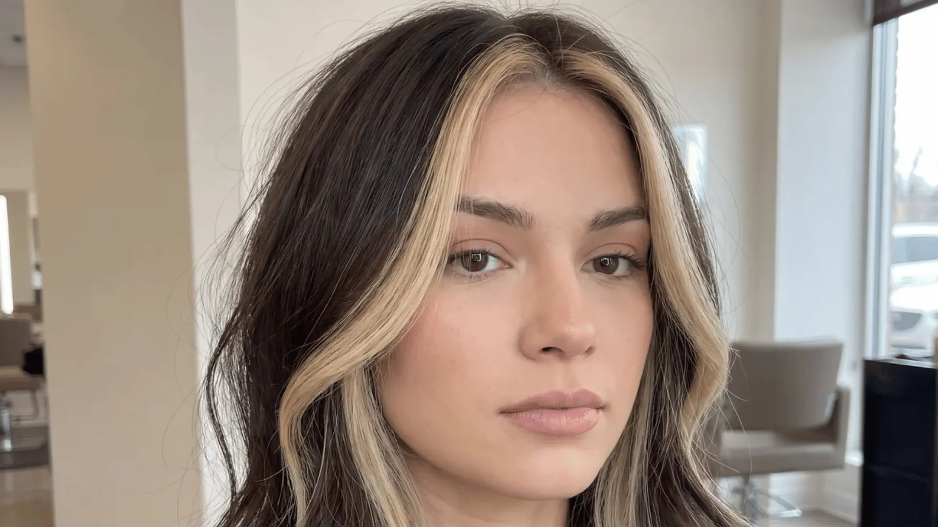 Face framing blonde highlights on dark hair around the front sections of the face