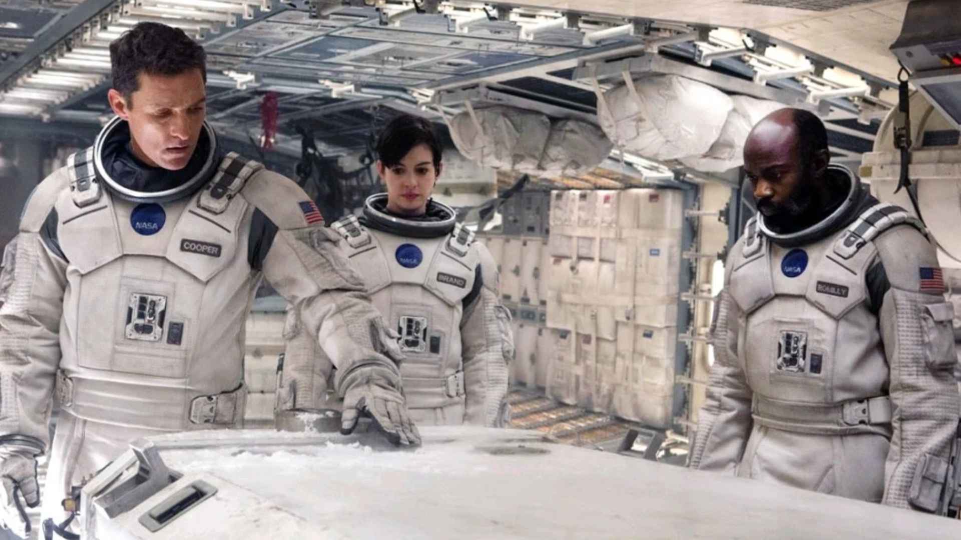 Cooper, Amelia Brand, and Romilly examine mission data aboard the Endurance spacecraft in Interstellar.