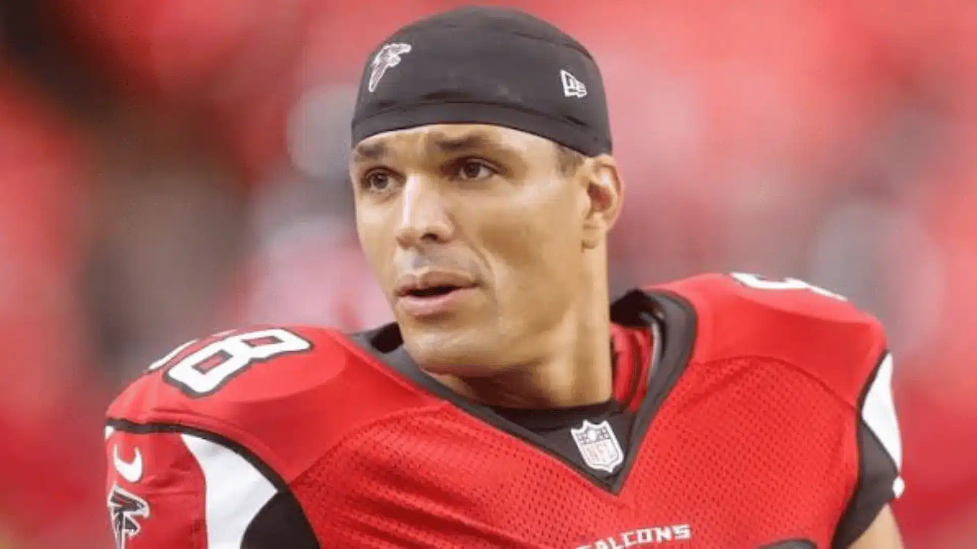 Football player wearing a Falcons jersey and black headband during a game