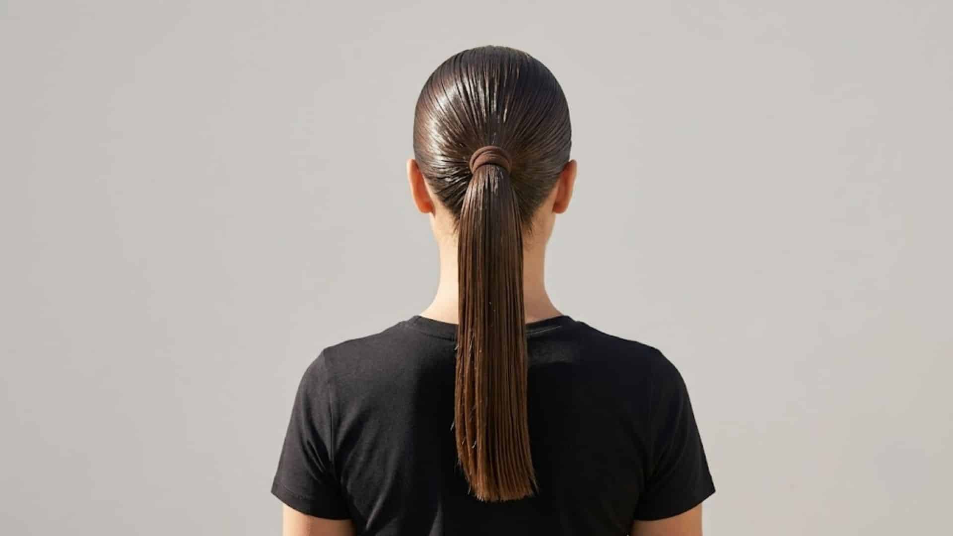 Back view of a glossy wet-look slicked ponytail on straight hair