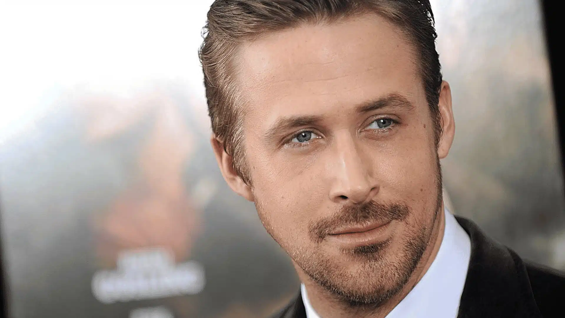 Close-up portrait of Ryan gosling in a suit with short hair